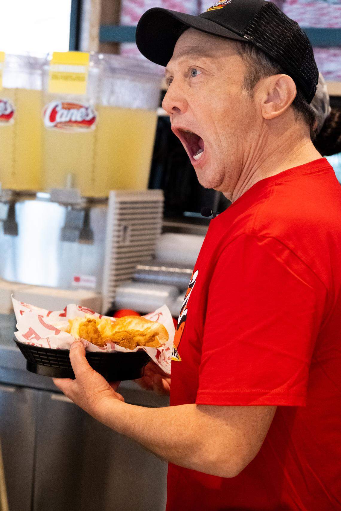 Rob Schneider works behind the counter at Raising Cane’s in Phoenix, Arizona.