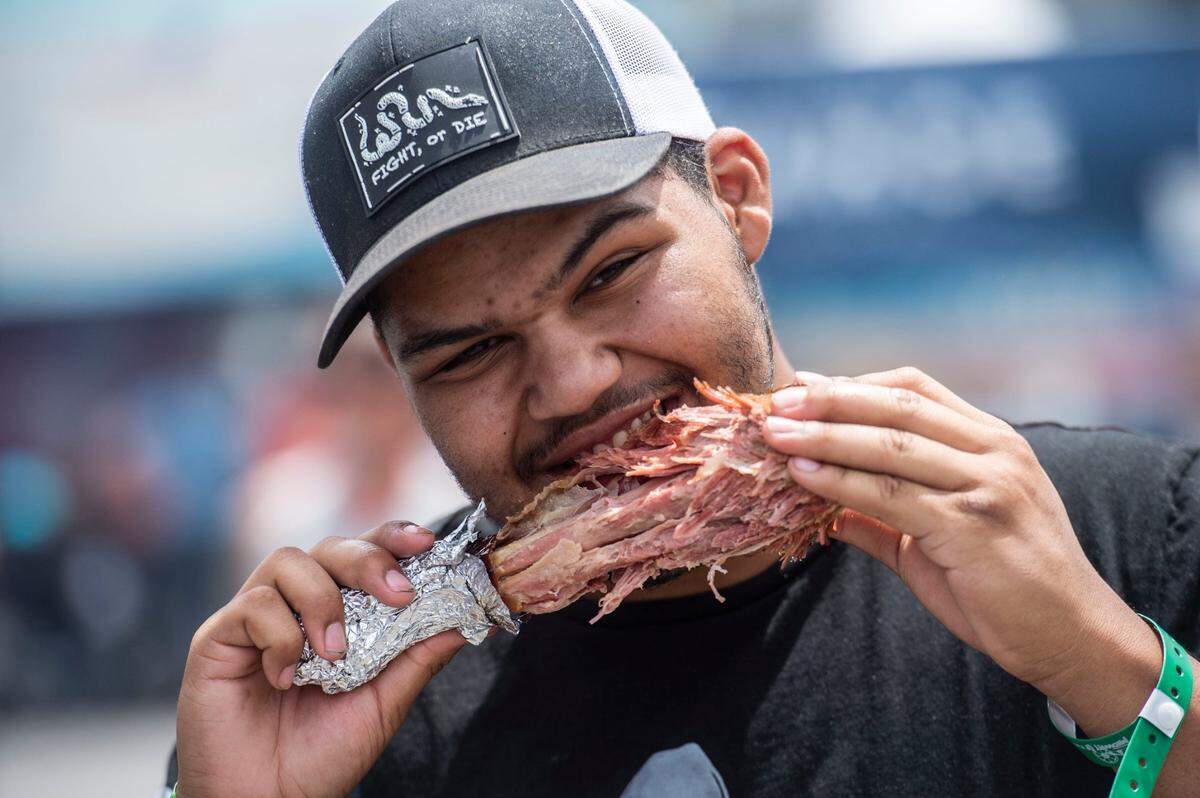 Elijah Lambert, 17, of Wilton, eats his first turkey leg at the Sacramento County Fair at Cal Expo during opening day on Thursday, May 26, 2022.