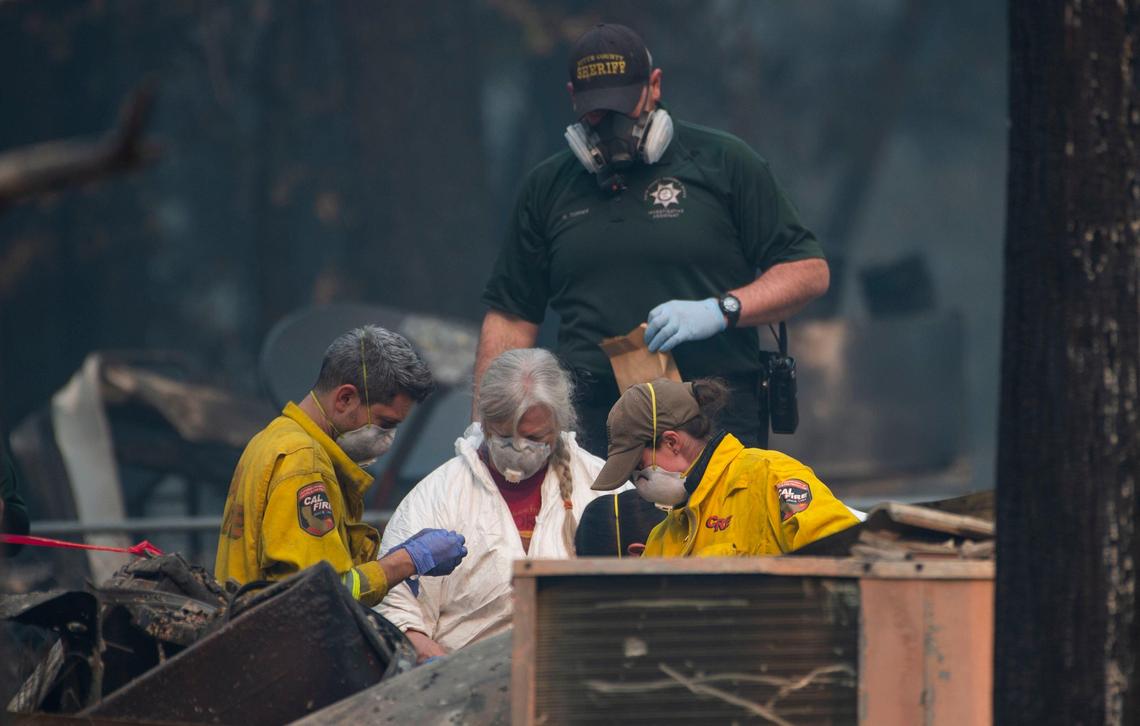 A search and rescue team from Cal Fire and El Dorado County look for a body on West Park Drive in Magalia on Thursday, Nov. 15, 2018. The Camp Fire burned many of the homes in the area.