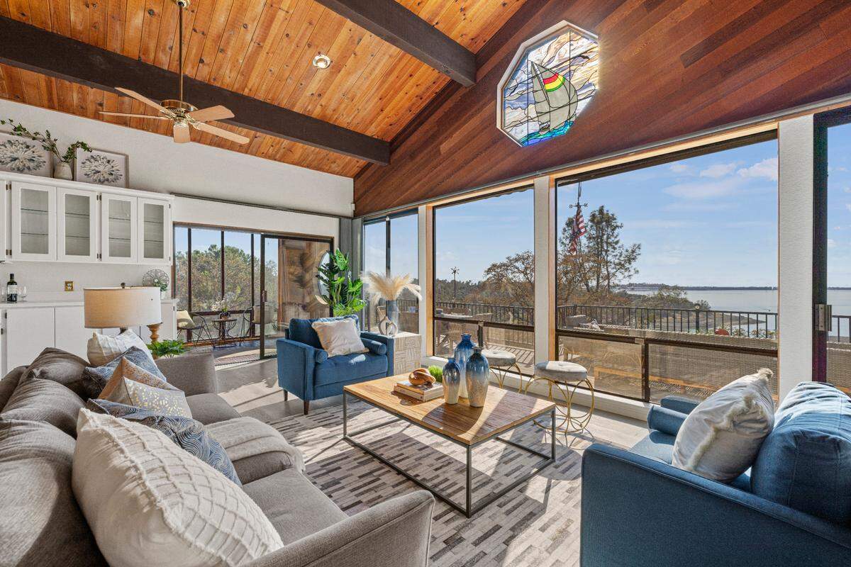 High, wood-beam ceilings in the living room are part of the home’s charm.