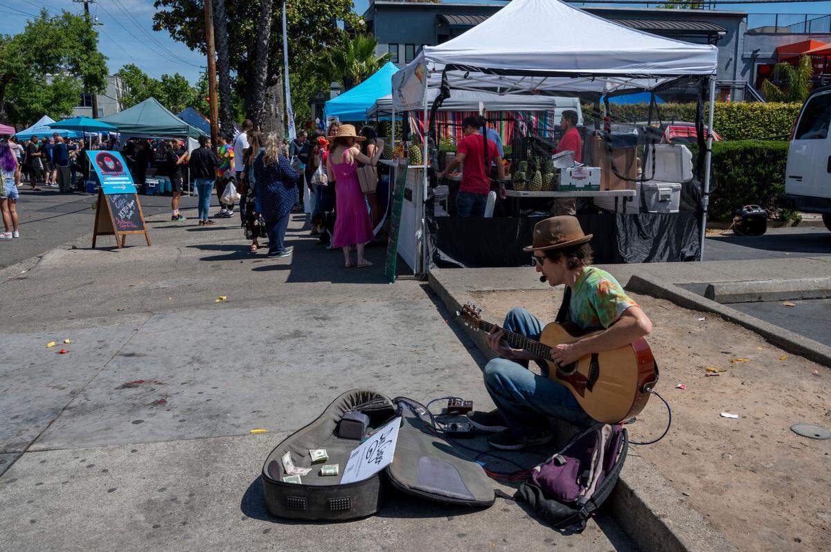 People shop at the Midtown Farmer’s Market on Saturday, April 30, 2022.