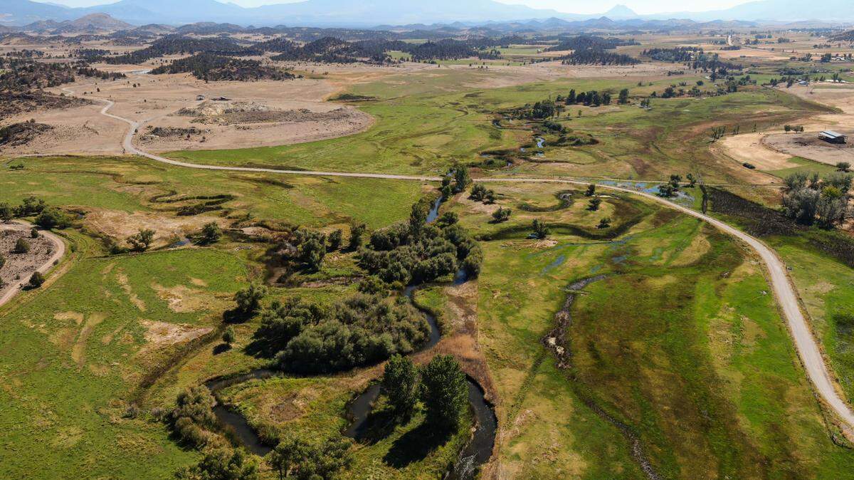 The Shasta River runs past a patchwork of private and public land, seen in a drone photo south of Montague overlooking Mount Shasta on Sept. 30, 2022, in Siskiyou County. The Little Shasta River is seen breaking eastward at left.