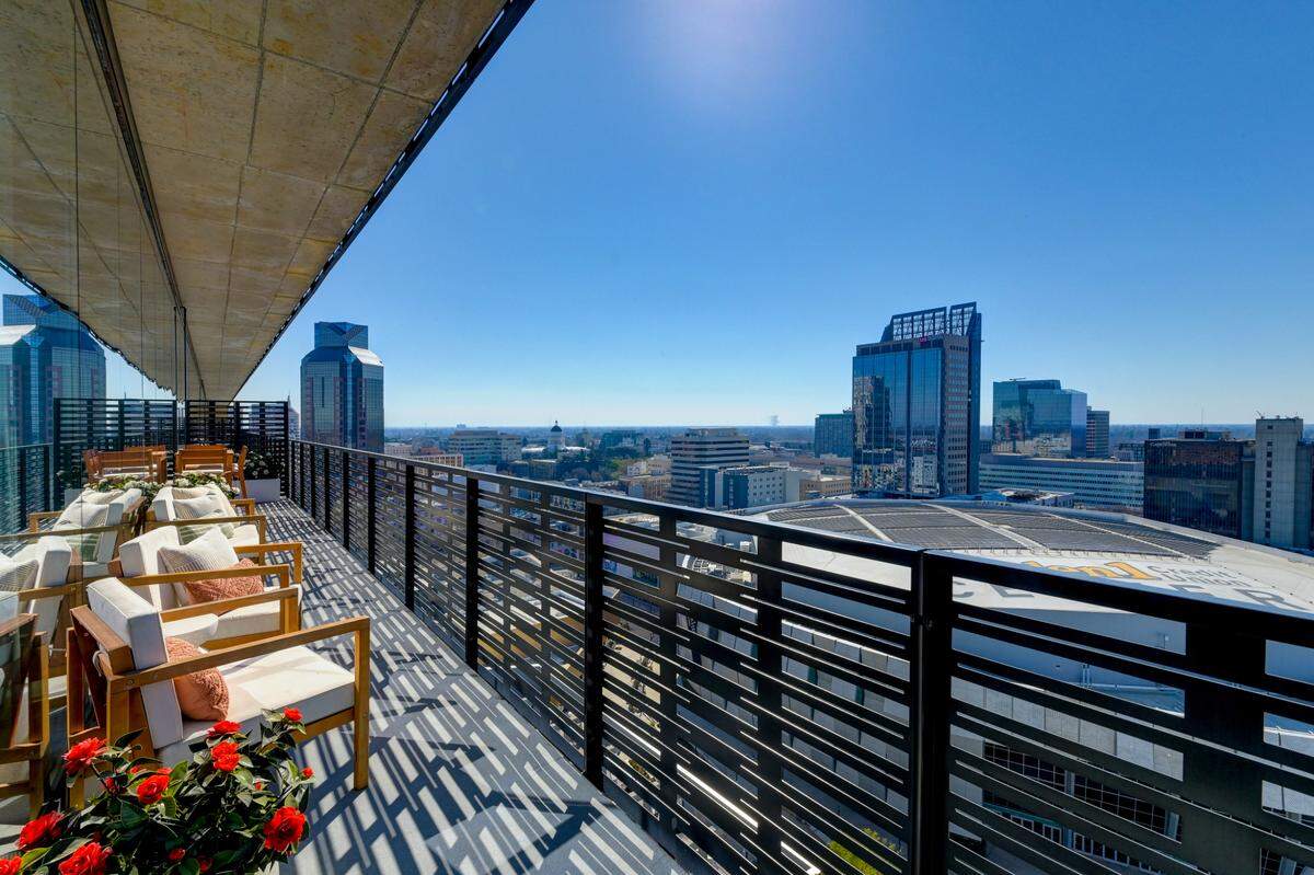 The expansive balcony of the downtown Sacramento penthouse offers space for al fresco dining and city views.