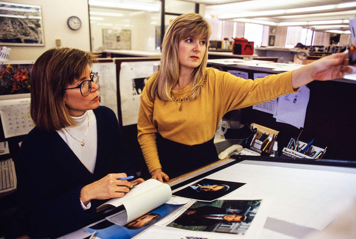 Designer Judy Jordan and features reporter Dixie Reid discuss a layout in The Sacramento Bee newsroom in 1991.