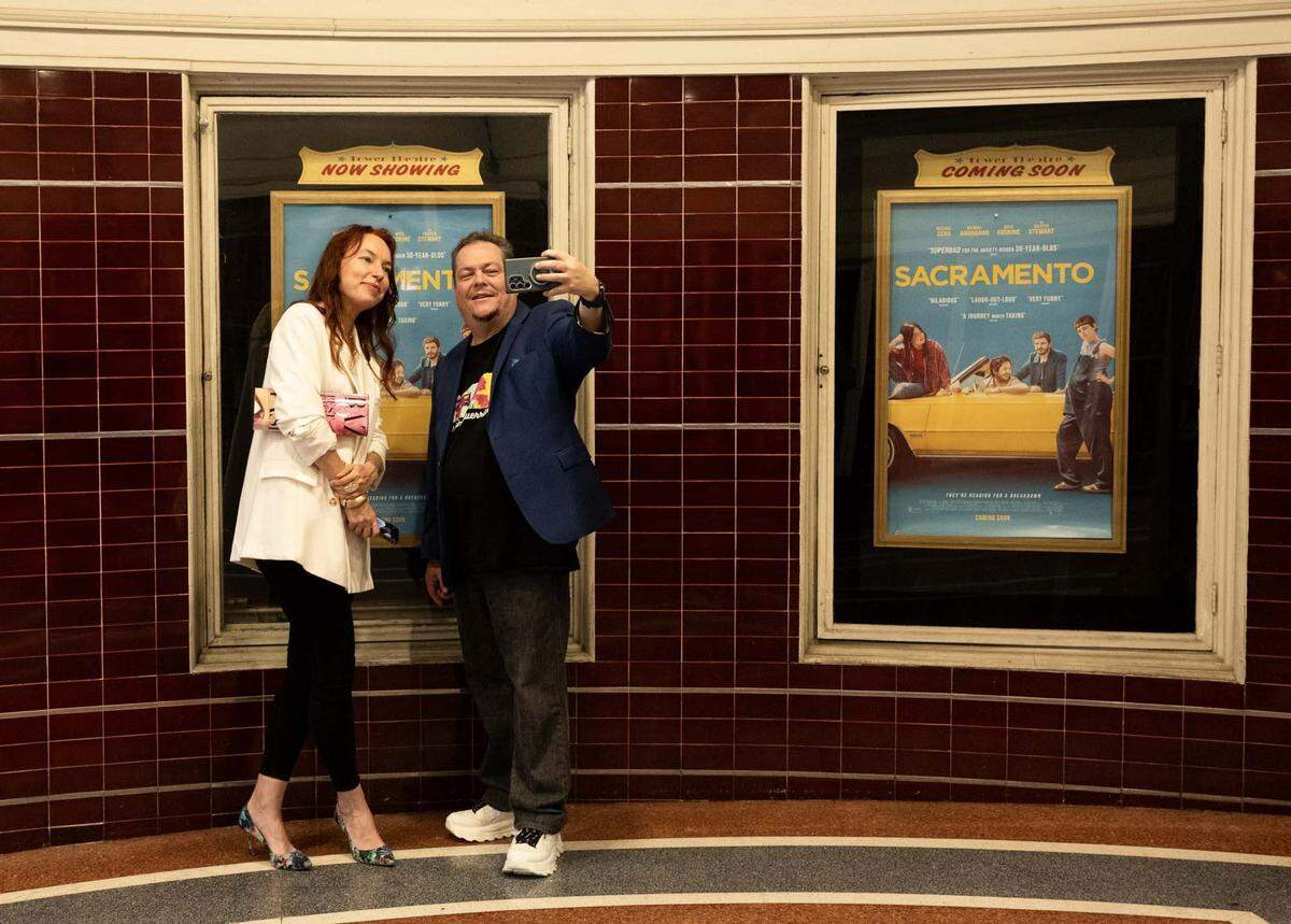 Martin Anaya talks a selfie with Anastasia Kryukova outside a special screening of the film ”Sacramento” at the Tower Theatre on Wednesday, days before it officially opened. Writer-director-star Michael Angarano attended a post-screening Q&A with co-writer Chris Smith.