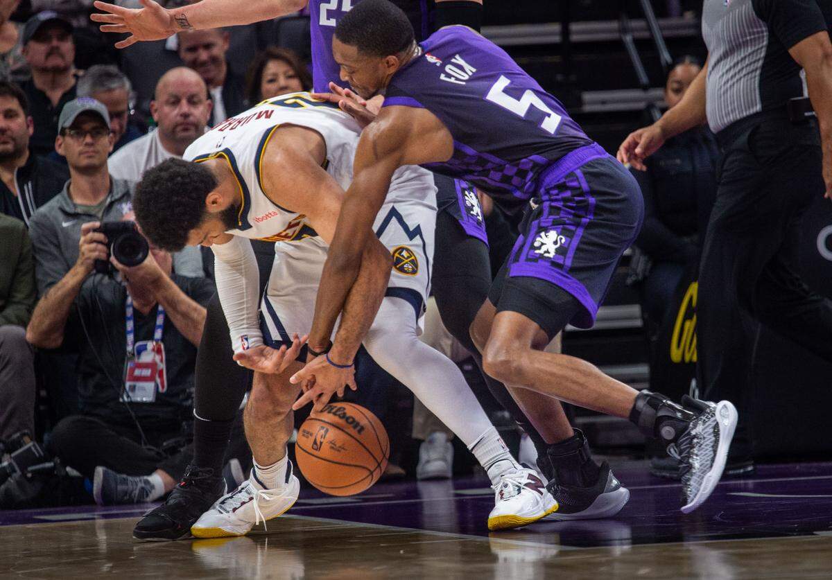 Sacramento Kings guard De’Aaron Fox (5) steals the ball from Denver Nuggets guard Jamal Murray (27) during an NBA game on Friday, Feb. 9, 2024 at Golden 1 Center.