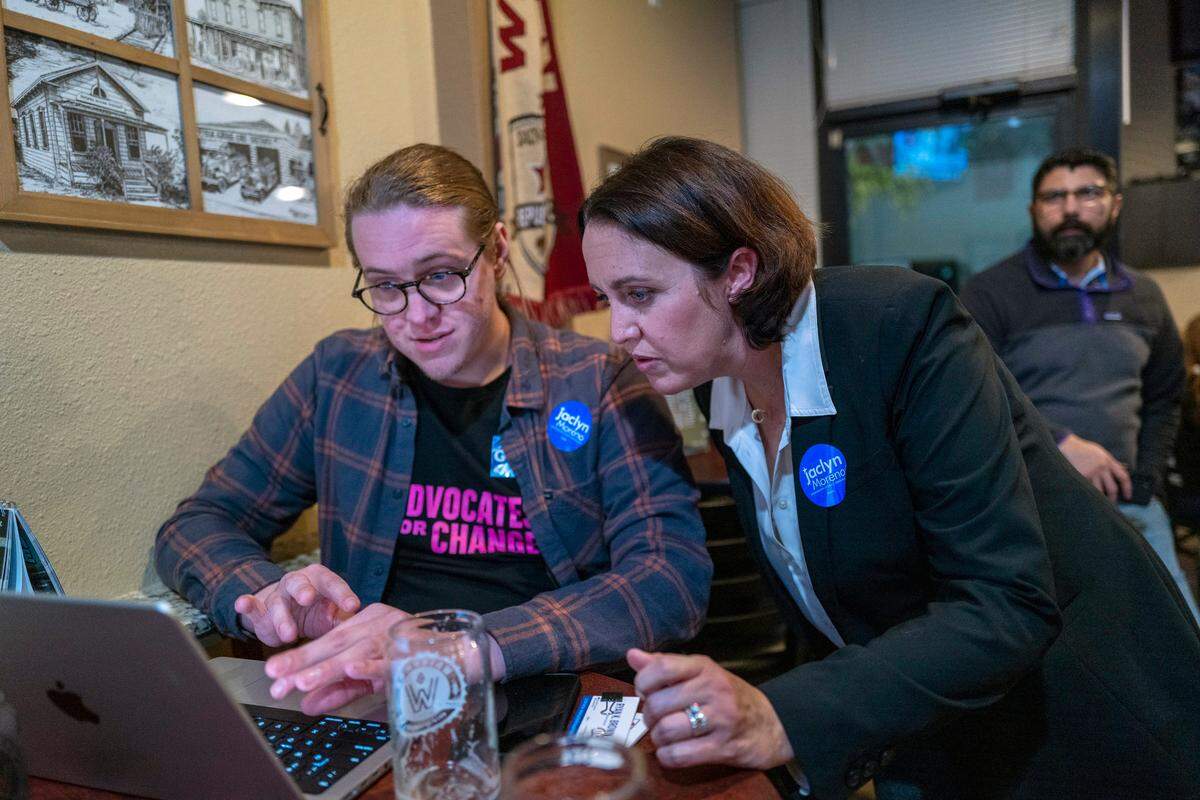 Sacramento County Board of Supervisors candidate Jaclyn Moreno, left, looks at close election results with campaign manager Ryan Brown, left, at an election night party at Waterman Brewing in Elk Grove on Tuesday, Nov. 8, 2022.