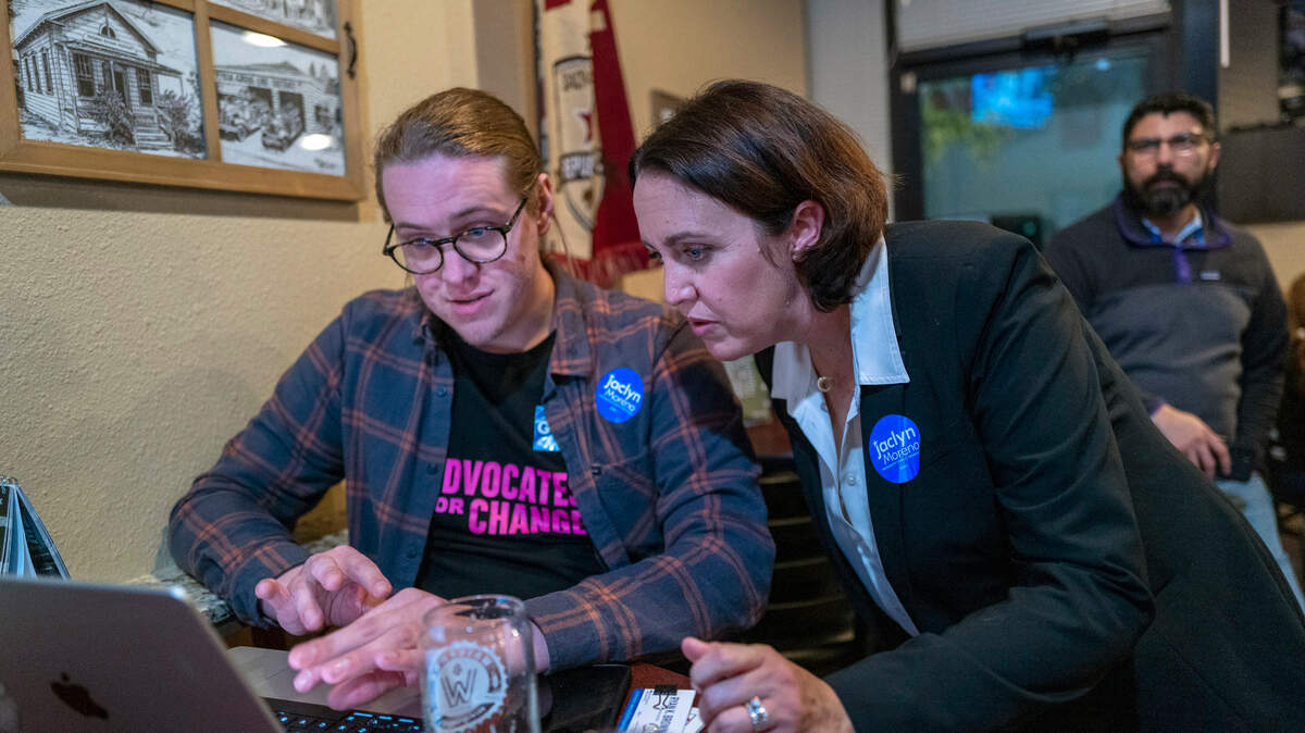 Sacramento County Board of Supervisors candidate Jaclyn Moreno, right, looks at close election results with campaign manager Ryan Brown, left, at an election night party at Waterman Brewing in Elk Grove on Nov. 8.