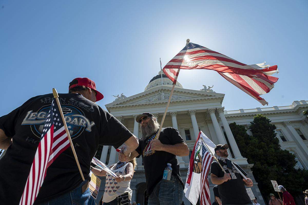 Protesters demonstrate at the Capitol in Sacramento on Friday, May 1, 2020, against Gov. Gavin Newsom’s stay-at-home order to slow the spread of the coronavirus.