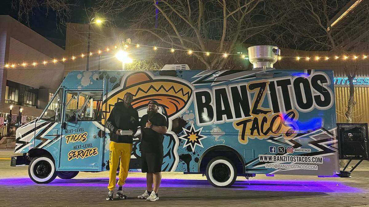 Banzito’s taco truck owner Adam Saldaña stands with the Sacramento Kings’ De’Aaron Fox as the beam shines above Sacramento.
