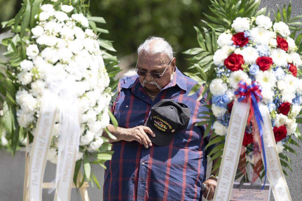 Phil Rios prays during a “Reading of the Names” ceremony at the California Vietnam Veterans Memorial in Sacramento on Sunday, May 24, 2026. Rios lost 11 classmates — including his friend Manuel Gines — in the Vietnam war.