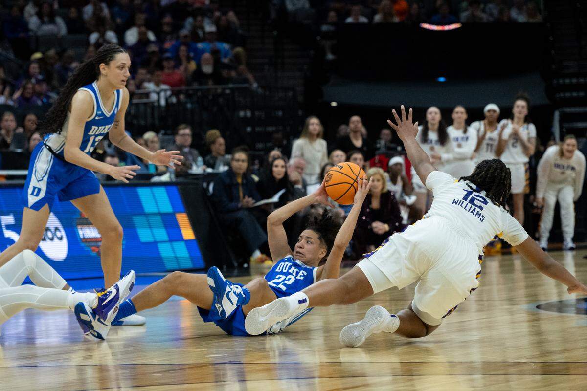 Duke Blue Devils guard Taina Mair (22) tries to pass the ball while being guarded by Louisiana State University Tigers guard Mikaylah Williams during the NCAA Women’s Basketball Tournament Sweet 16 game at Golden 1 Center in Sacramento on Friday.