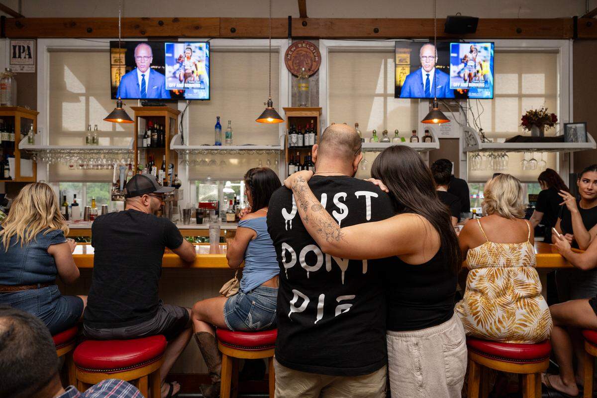 James Elias wears a shirt that says, “Just Don’t Die” as his fiancé Tiffany Monroy embraces him as they wait near the bar at Rio City Cafe in Old Sacramento on Friday. Monroy worked at the Rio City Cafe when she was in high school, and hadn’t been back for several years until tonight for nostalgic reasons.