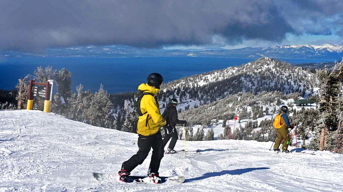 Above a crystal clear view of Lake Tahoe, a snowboarder explores fresh powder at Heavenly Ski Resort this past winter.