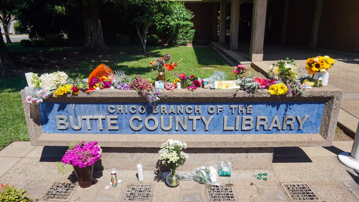 Flowers form a memorial on Wednesday for the victims of a shooting at the Chico branch of the Butte County Library.