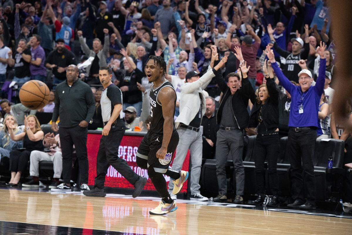 Sacramento Kings guard Davion Mitchell (15) celebrates a three point basket with the home crowd during Game 2 of the first-round NBA playoff series at Golden 1 Center on Monday, April 17, 2023.