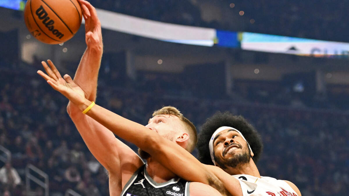 Cleveland Cavaliers center Jarrett Allen, right, fights for a rebound against Sacramento Kings forward Domantas Sabonis during the first half of an NBA basketball game, Friday, Dec. 9, 2022, in Cleveland. (AP Photo/Nick Cammett)