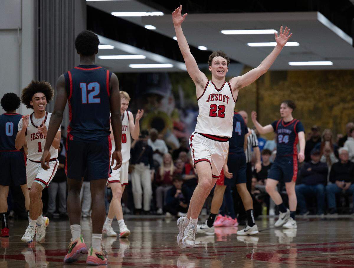 The Jesuit Marauders’ Asher Schroeder (22) celebrates the CIF Northern California Division II boys basketball championship following the 65-55 victory over the Destiny Christian Lions on Tuesday in Carmichael.