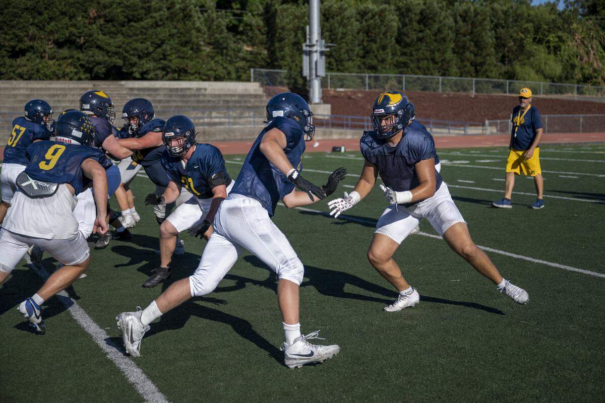 An offensive linemen charges at defensive end Javon Joseph in an attempt to protect the running back during a football practice at Oak Ridge High School in El Dorado Hills on Tuesday, Aug. 5, 2025.