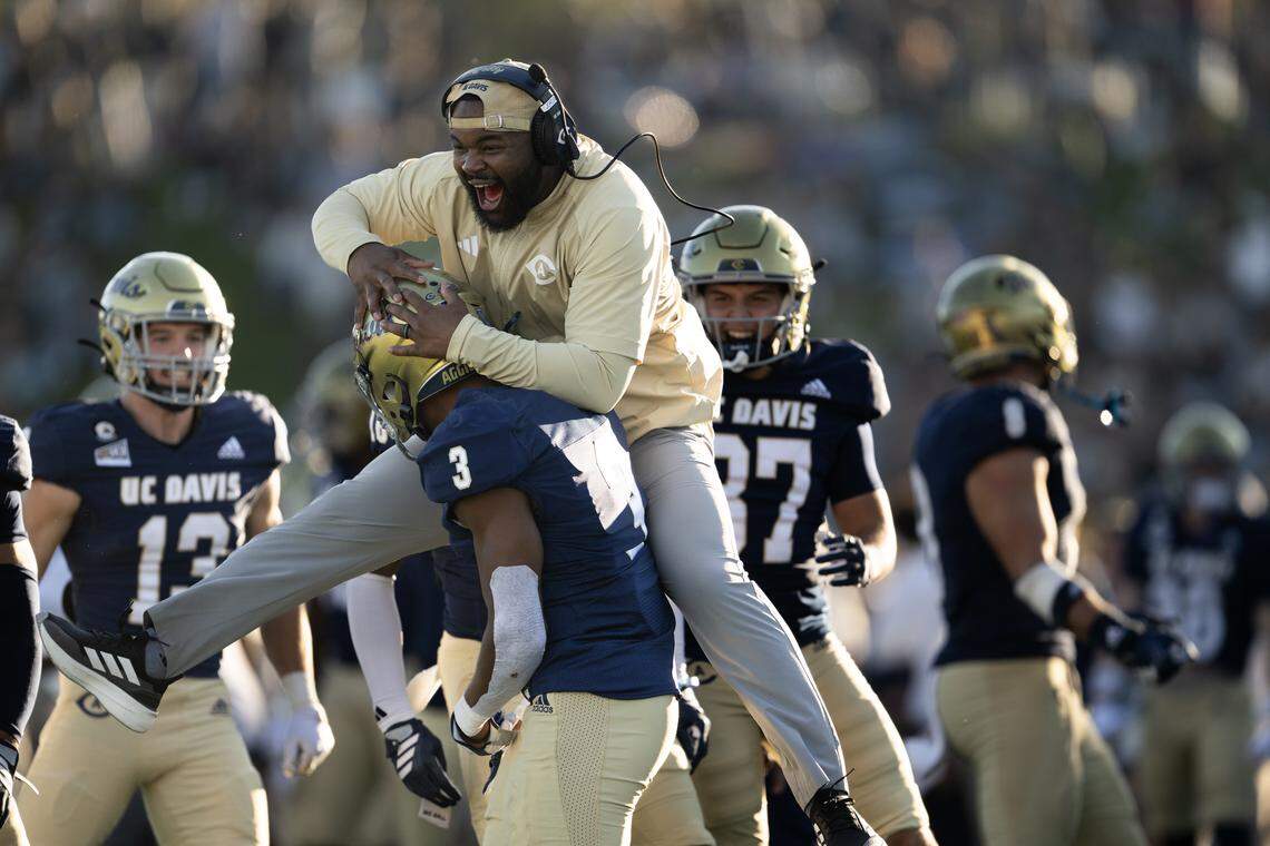 UC Davis Aggies cornerback coach DeMaurier Jordan celebrates after defensive back Ty Richardson (3) intercepted a pass in the second half in the Causeway Classic on Saturday, Nov. 22, 2025 in Davis.