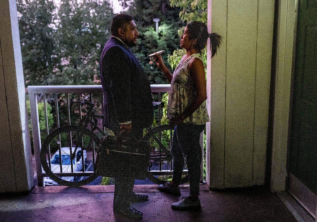 Colombian migrant Aura records a conversation with Jorge de la Cruz with law firm Mendoza Immigration in August as he explains the process to seek asylum. She is one of the migrants that arrived in Sacramento this summer from Texas on a flight paid for by the state of Florida.