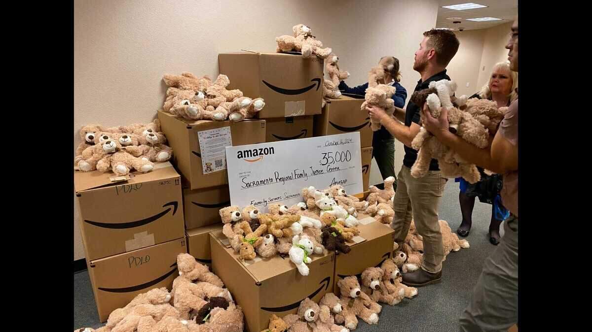 Employees with Amazon and the Sacramento Regional Family Justice Center stack teddy bears Wednesday donated by Amazon employees to the center at the Sacramento Regional Family Justice Center at 3701 Power Inn Road.