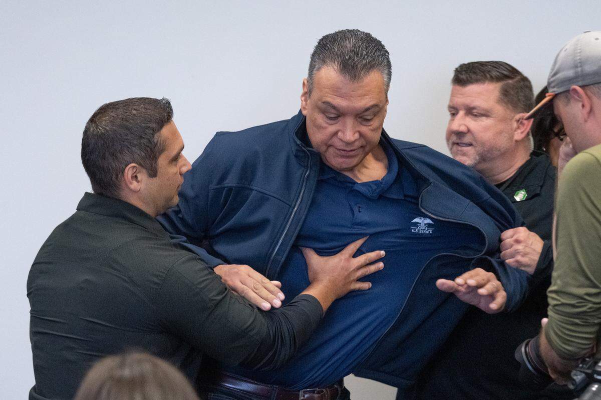 California Sen. Alex Padilla is pushed out of the room as Homeland Security Secretary Kristi Noem holds a news conference in Los Angeles on Thursday, June 12, 2025. 