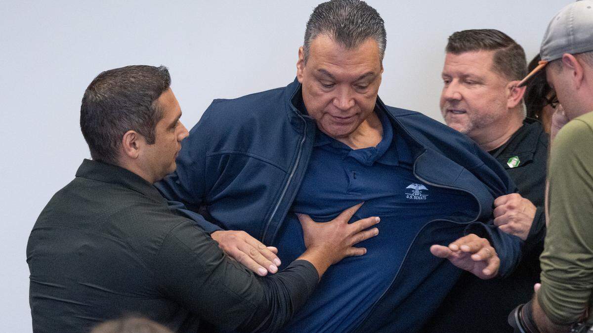 California Sen. Alex Padilla is pushed out of the room as Homeland Security Secretary Kristi Noem holds a news conference in Los Angeles on Thursday, June 12, 2025. 