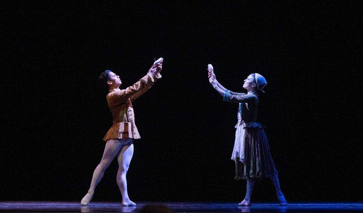 Prince Charming (Victor Maguad) and Cinderella (Michelle Katcher) hold up ballet shoes as they imagine finding each other again during a Sacramento Ballet dress rehearsal of Cinderella on Thursday, Feb. 15, 2024, at the SAFE Credit Union Performing Arts Center.