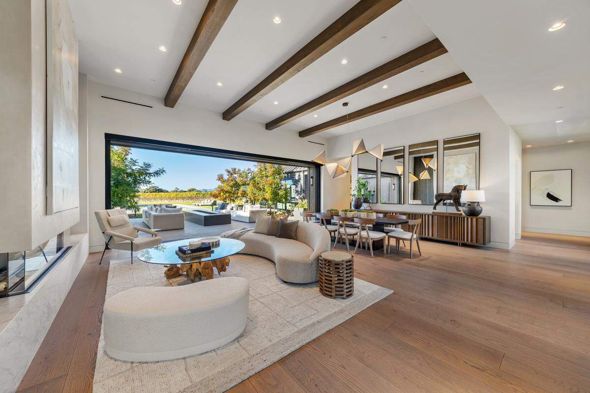 The main home offers 6,927 square feet, 4 bedrooms, 5.5 baths, and dramatic spaces filled with natural light and custom finishes.