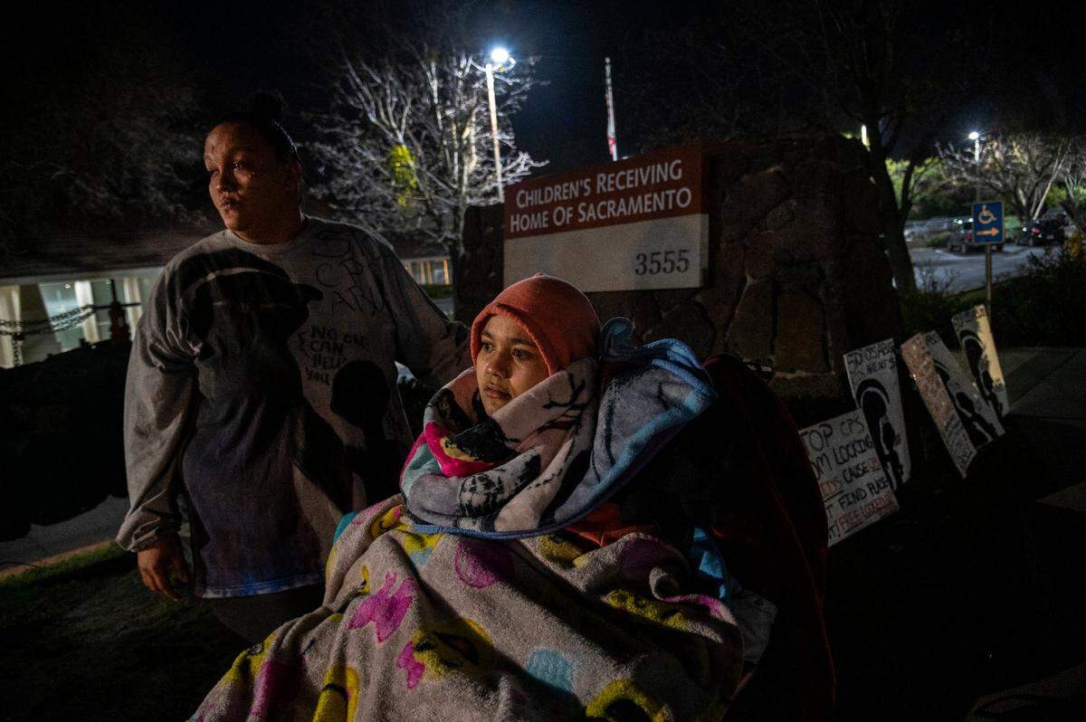 Felicia Brent-Velasquez, 18, is bundled up in blankets in her wheelchair as she joins her mother Felicia Clark, 36, in protest outside the Children’s Receiving Home of Sacramento in February. “It’s hard to see the things that I see out there, but that’s why I keep going back,” said Clark.