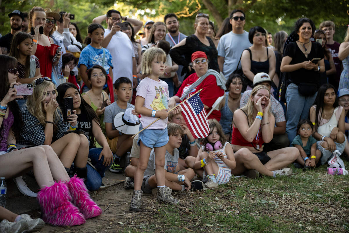 Spectators watch the hot dog eating contest at the Fourth of July celebration at Hagan Community Park in Rancho Cordova on Friday.