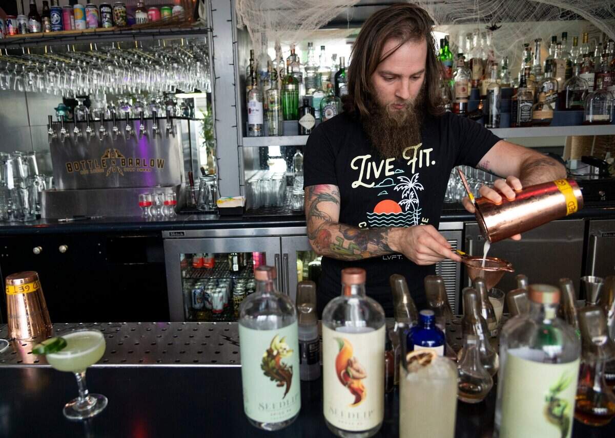 Bar manager Kyle Rioux makes mocktail drinks at Bottle & Barlow in Sacramento in November. Bottle & Barlow introduced a nonalcoholic cocktail program last year in addition to their traditional bar program.