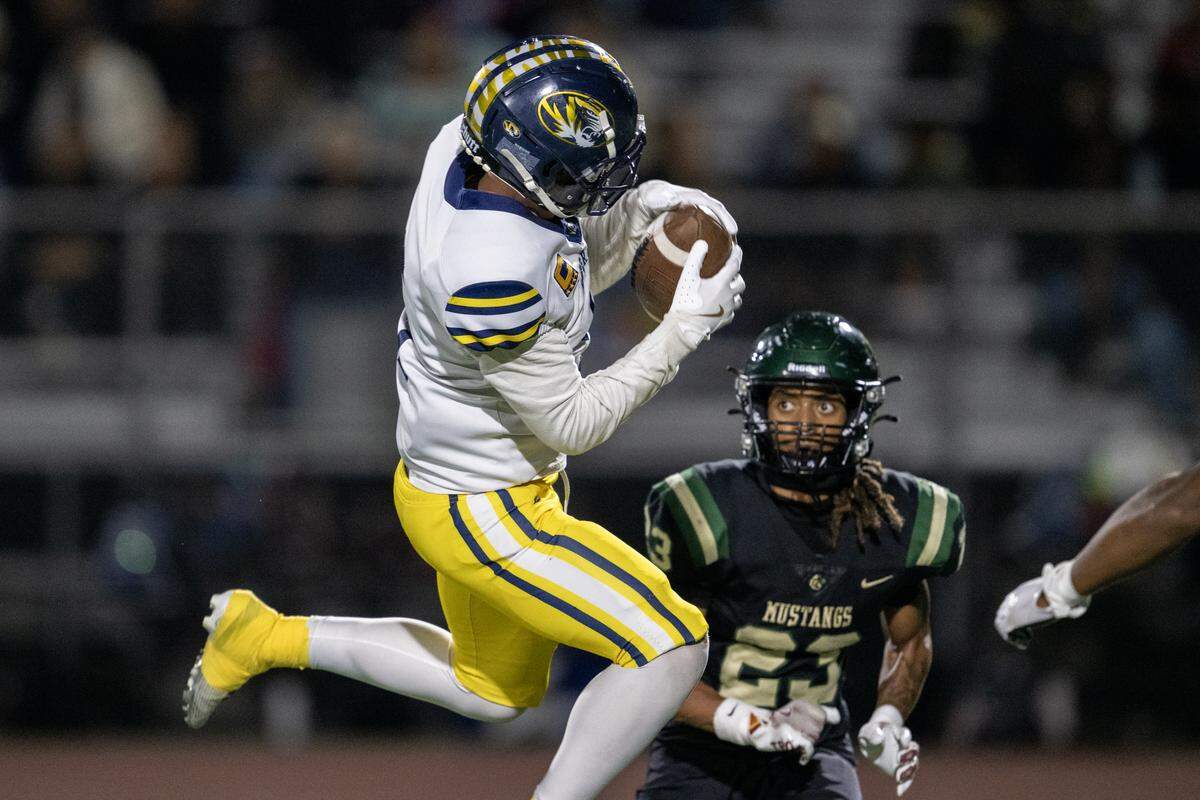 The Inderkum Tigers’ Jordan Cole (5) makes a catch in the first half in front of the Monterey Trail Mustangs’ Odie Jefferson (23) in the CIF Sac-Joaquin Section Division l quarterfinal football playoff game at Monterey Trail High School on Friday in Elk Grove.