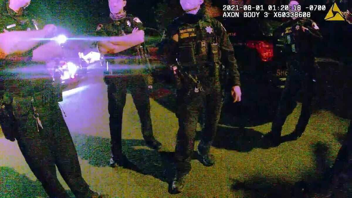 In an image taken from sheriff’s body-worn video, deputies are seen discussing the events during the arrest of Larry Weigle following a police pursuit in the South Oak Park section of Sacramento on Aug. 1, 2021. In footage from at least two body-worn videos, a supervisor is heard asking the deputies who Weigle fought with during the arrest. Deputy Hunter Greenwood is identified as the deputy who “kicked” Weigle before Greenwood is heard saying “I just pushed him.” Greenwood later told investigators that he stomped on Weigle’s right shoulder twice because he perceived that Weigle’s hands were under his body, something he conceded was inaccurate after viewing video of the arrest.