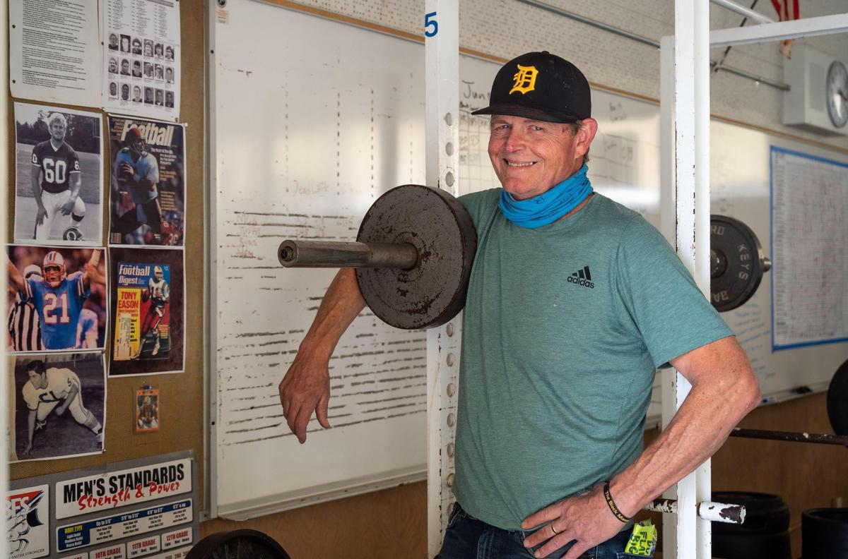 Delta High School football co-head coach Ed Call stands in the weight room near a wall of Saints successes on Wednesday, Oct. 20, 2021, in Clarksburg.