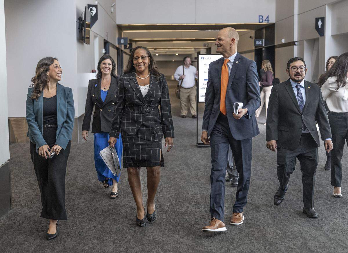 Sacramento Councilmember Karina Talamantes, left, and Mayor Kevin McCarty, right, walk with new City Manager Maraskeshia Smith, center, before her introductory news conference on Tuesday.