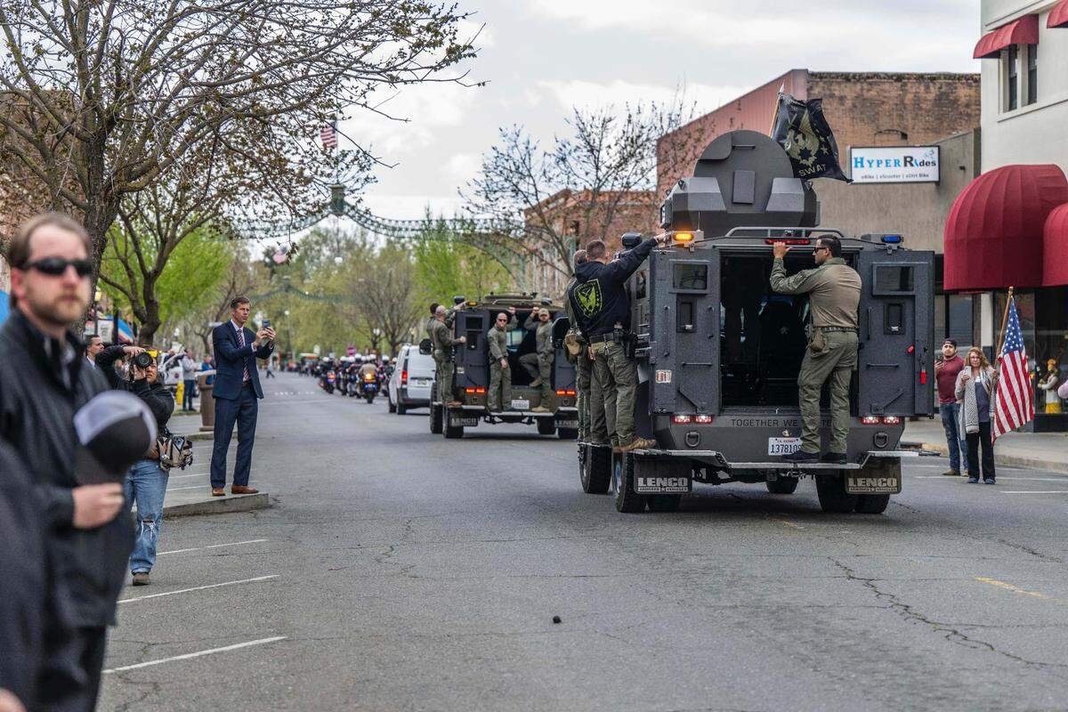 Marysville Police SWAT team members follow a procession through downtown carrying the body of fellow officer Osmar Rodarte on Thursday, a day after he was killed in the line duty.