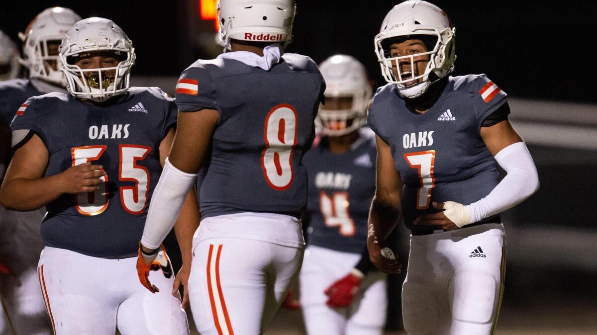 Cosumnes Oaks quarterback Anthony Grigsby communicates on the field during a fourth down in the second quarter against Monterey Trail at the high school football game Friday, April 2, 2021, at Monterey Trail High School in Elk Grove. Monterey Trail beat Cosumnes Oaks 57-21.