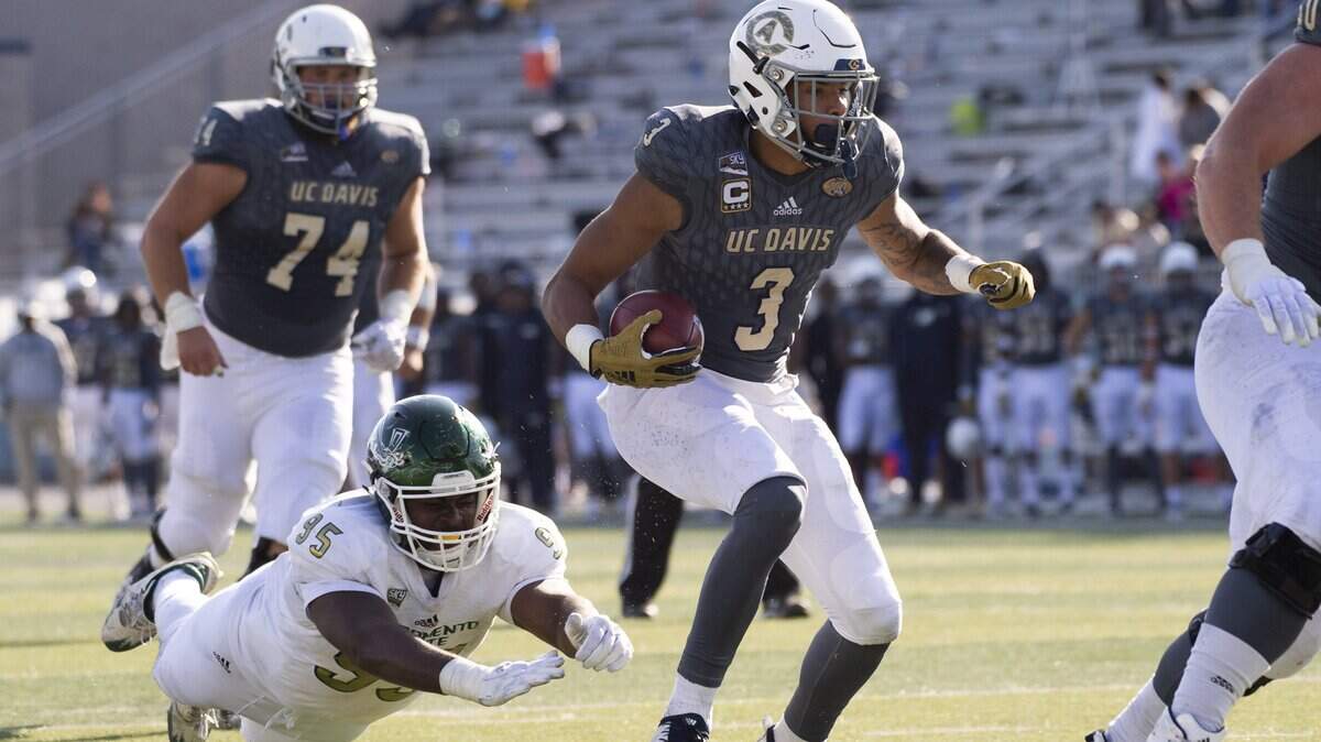 UC Davis receiver Keelan Doss (3) leaves Sacramento State’s Dariyn Choates (95) diving at air as he looks for room to run after one of his career-high 16 catches during the 65th Causeway Classic on Nov. 17, 2018, in Reno, Nev. Doss had 205 yards and two touchdowns in a 56-13 victory. On Dec. 18, Doss was named to the STATS FCS All-America first team for the second year in a row.