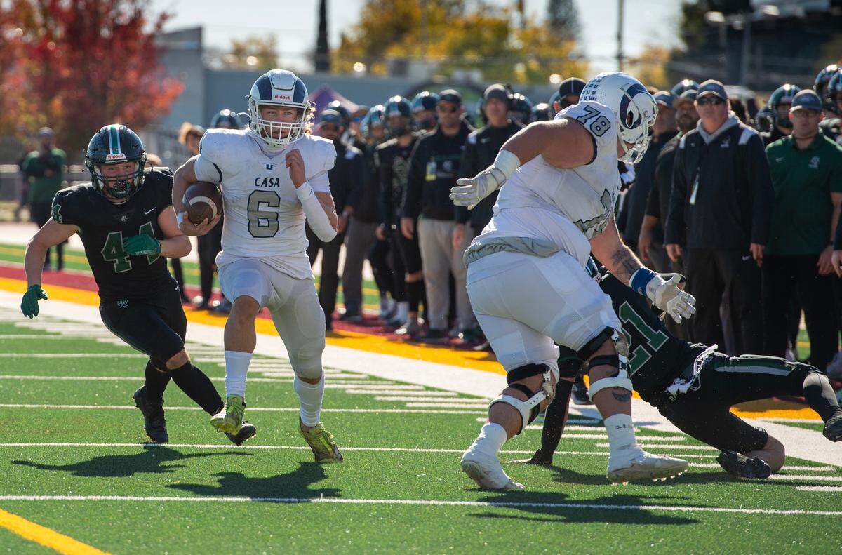 The Casa Roble Rams’ Braylen Blevins (6) picks up a block by tackle Ethan Elder (78) on his way to a 27-yard catch and run touchdown during the second quarter of the CIF Sac-Joaquin Section Division V football championship game on Friday at Hughes Stadium.