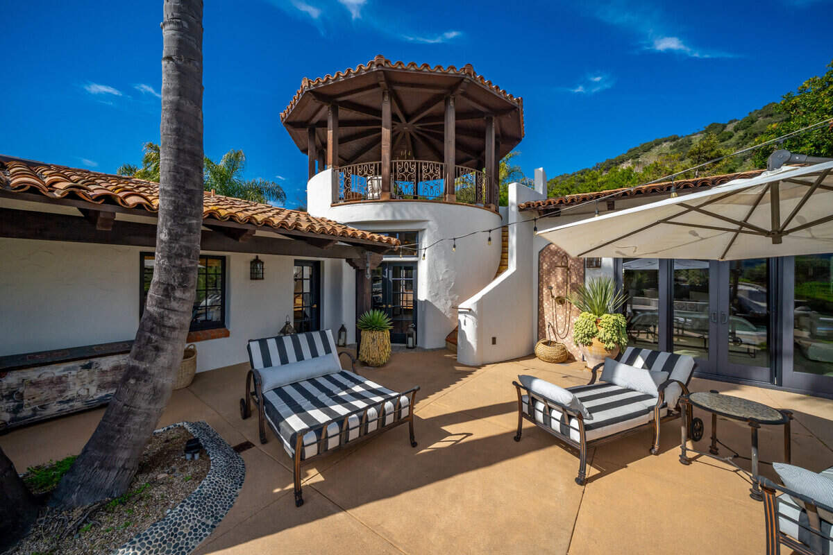 An outdoor spiral staircase at Casa Contenta leads up to an observation tower for panoramic views of vineyards and lush hills in Avila Beach. The property is for sale for $7.4 million.