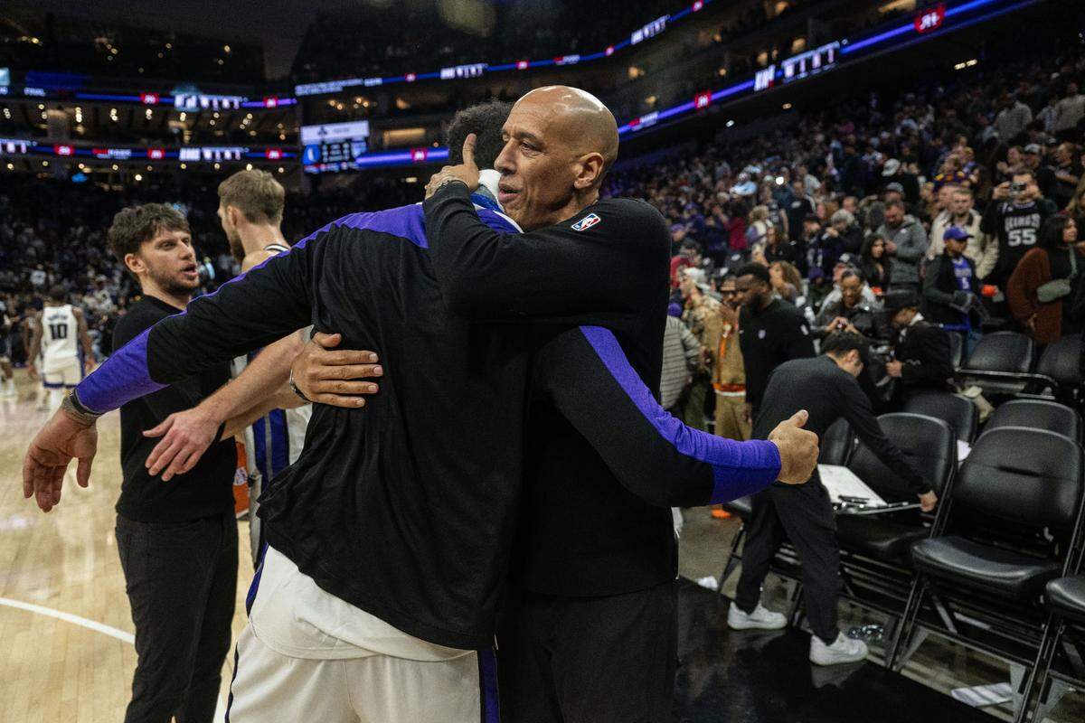 Sacramento Kings forward Trey Lyles (41) is congratulated by interim coach Doug Christie after their victory against the Dallas Mavericks on Dec. 30 at Golden 1 Center.