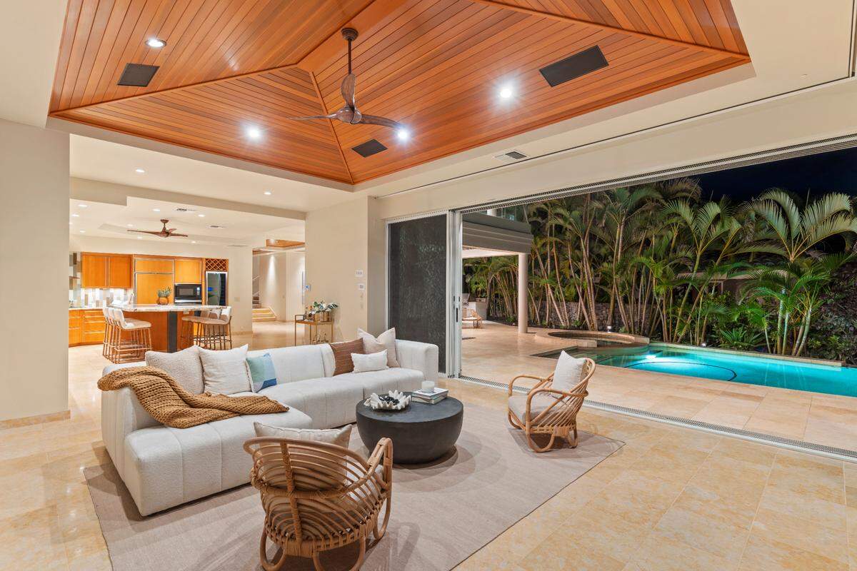 Two distinct living spaces and the dining room open out to the pool and spa.