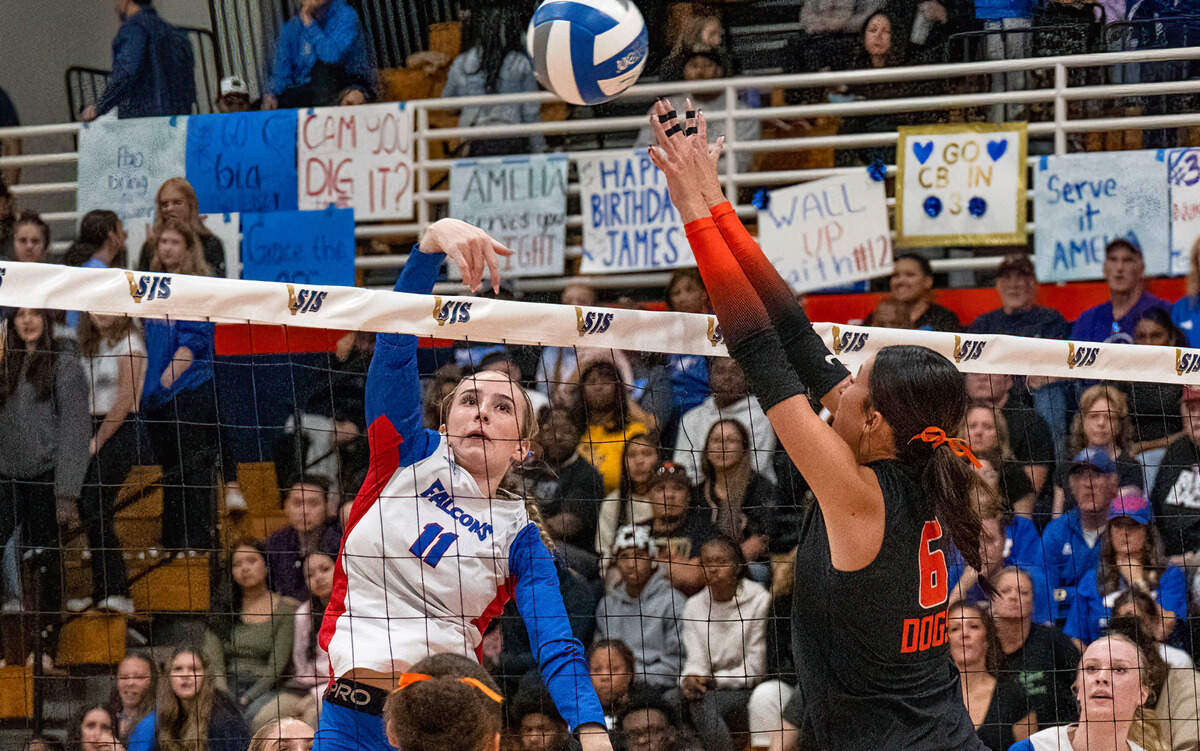 The Vacaville Bulldogs’ Gianna Brunie (6) attempts to block the Christian Brothers Falcons’ Raegan Dineen (11) during the Sac-Joaquin Section Division II volleyball championship final at Cosumnes River College on Saturday.