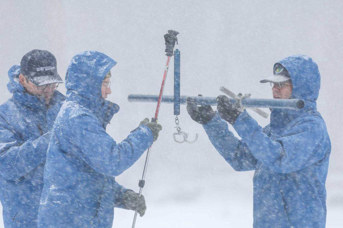Department of Water Resources engineers Chan Modini, left, and Anthony Burdock, along with survey manager Andy Reising, right, conduct the second manual snow survey of the 2025 season at Phillips Station on Jan. 31, 2025. The average snowpack statewide was at 108% of normal at the start of January, but the absence of major storms since has driven it down to 65%.