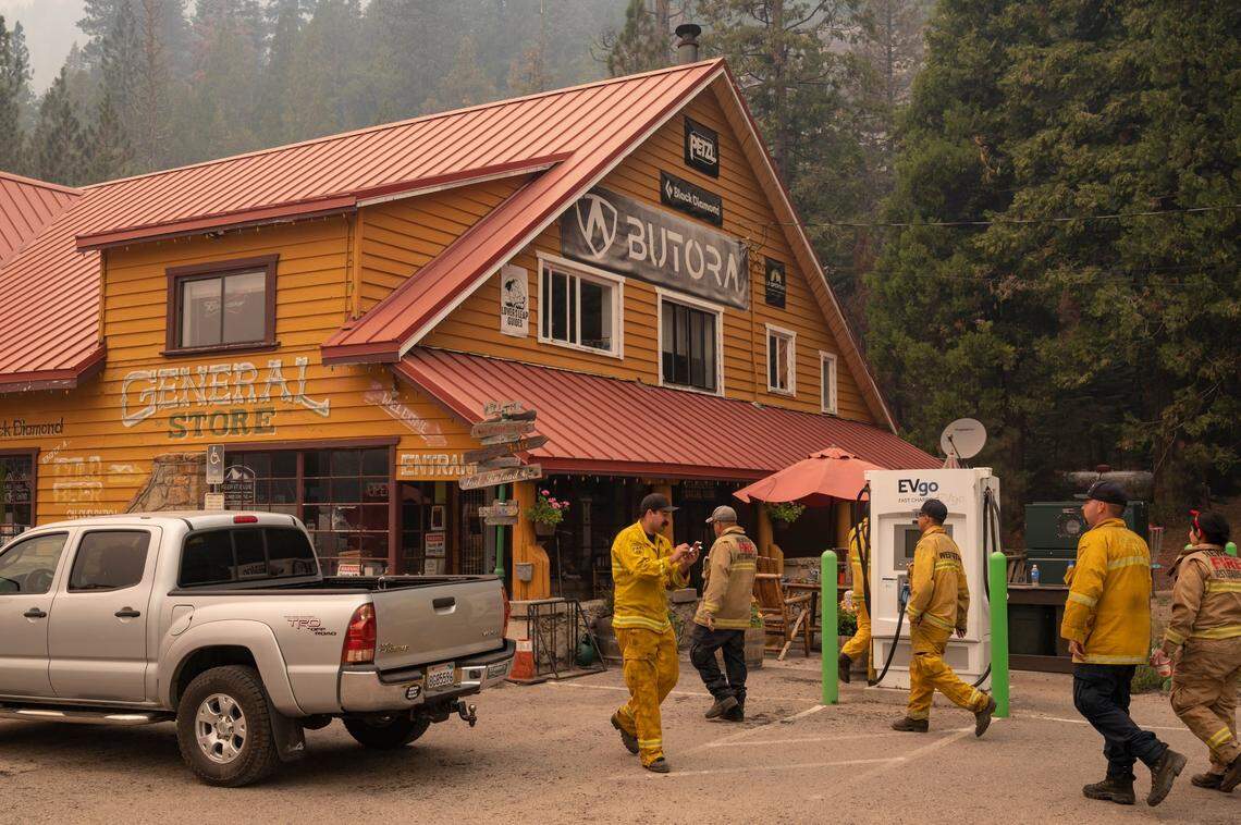 Firefighters take a break from fighting the Caldor Fire to get free ice cream before it was discarded at the Strawberry Station General Store on Highway 50 on Sunday, Aug. 22, 2021.