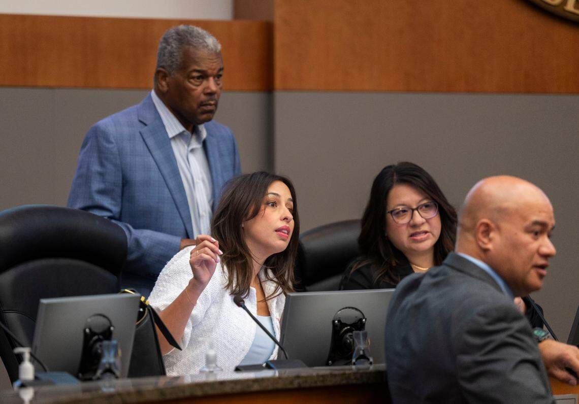 Sacramento City Councilmember Karina Talamantes, who is the vice chair of the Railyards Public Financing Authority, and Councilmember Rick Jennings look to the gallery as a group protests the financing of the Railyards project on Tuesday.