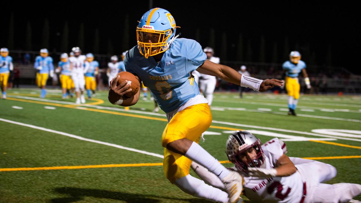 Center quarterback Michael Wortham evades a tackle by Bear River running back Colton Jenkins on Friday, Oct. 4, 2019, just before running out of bounds inches from the goal line.
