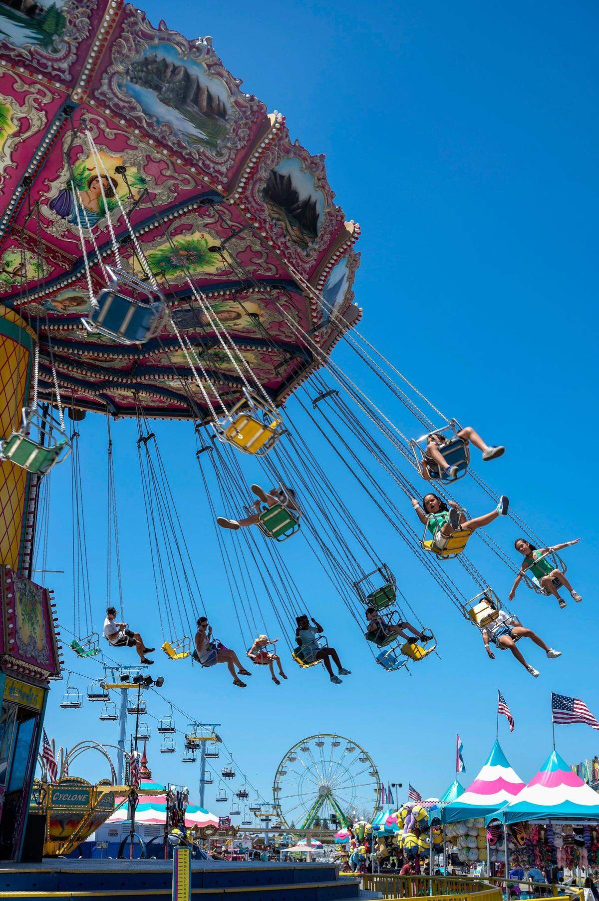 Guests ride the Wave Swinger ride at the California State Fair on Sunday, July 17, 2022, at Cal Expo.